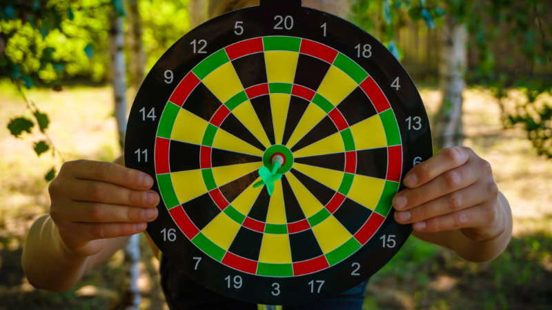 A dartboard with a dart in the bullseye.